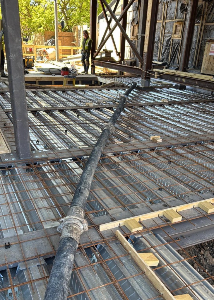 A King Concrete Pumping line pump feeding concrete on site near Crawley
